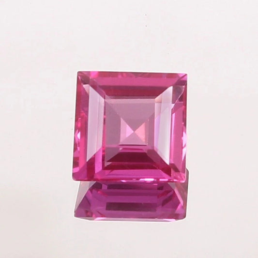 Pink Sapphire gemstone with a clear cut on a light pink background