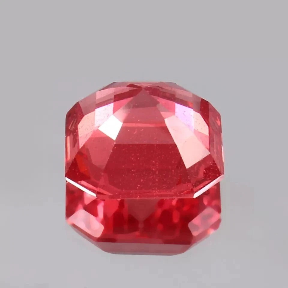 Solomon Color Untreated Padparadscha Sapphire gemstone on a gray background
