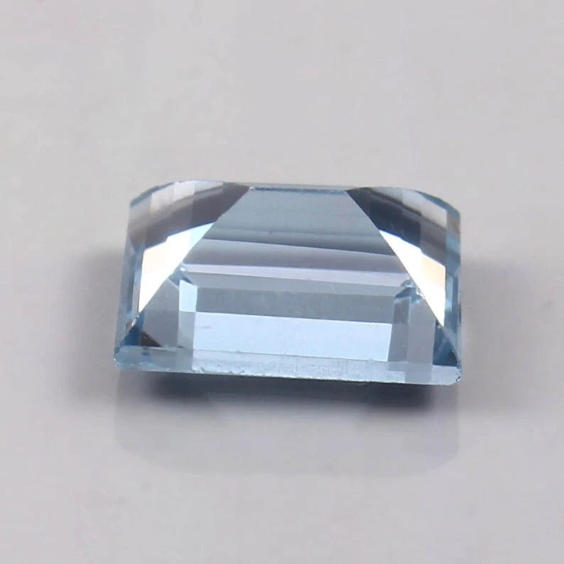 Brazilian Aquamarine Loose Baguette Cutblue gemstone on a light gray background