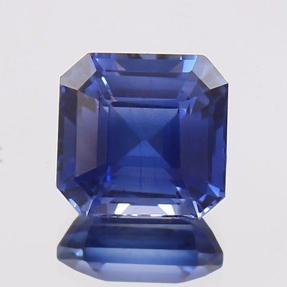 Faceted Royal Blue Sapphire on a light gray background
