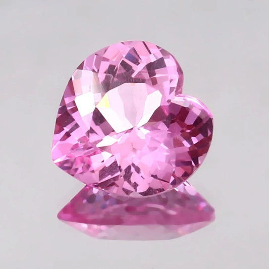 Heart-shaped Pink Morganite gemstone on a light gray background