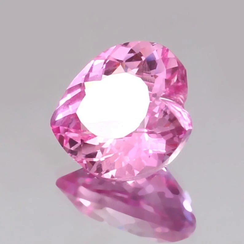 Pink Morganite gemstone on a gray background