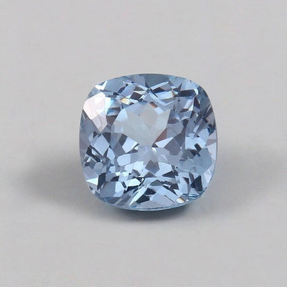 Cushion-shaped blue Aquamarine gemstone on a gray background