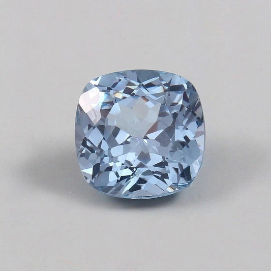 Cushion-shaped blue Aquamarine gemstone on a gray background