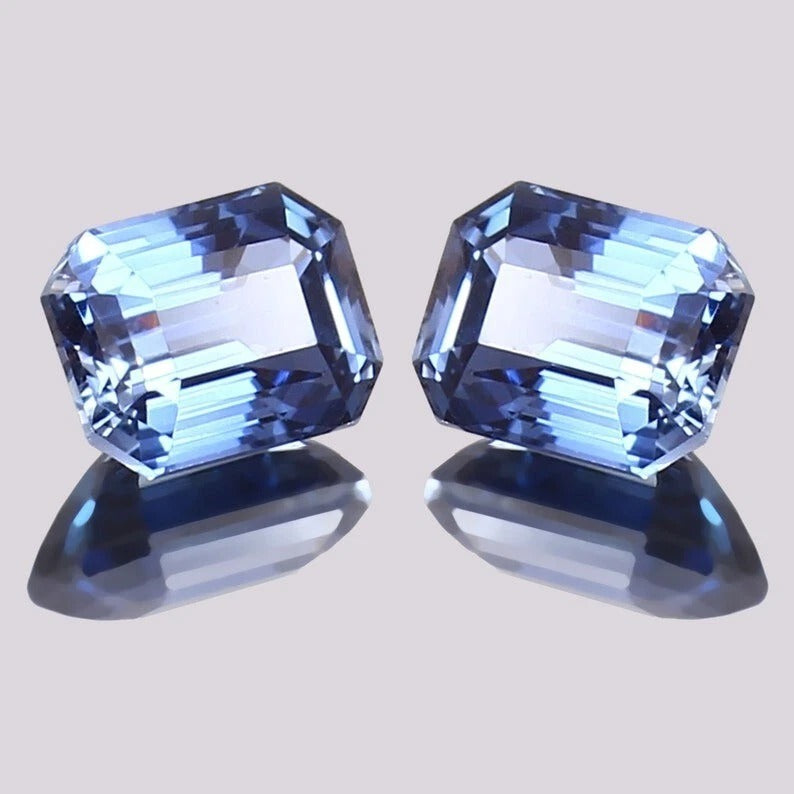 Blue Sapphire Pair gemstones with a light gray background