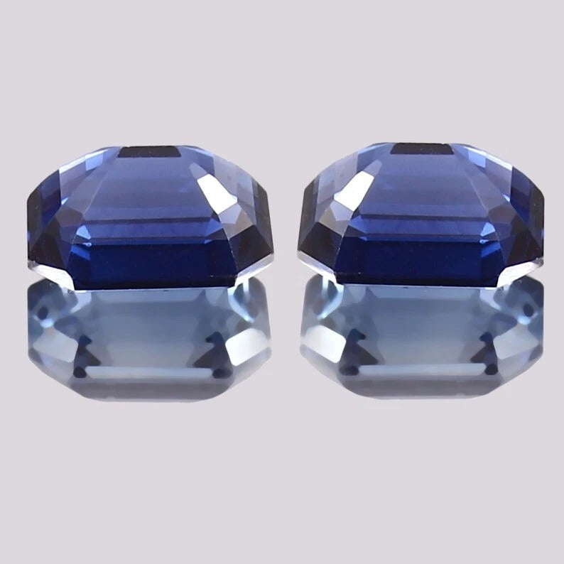 Blue Sapphire Pair gemstones on a light gray background