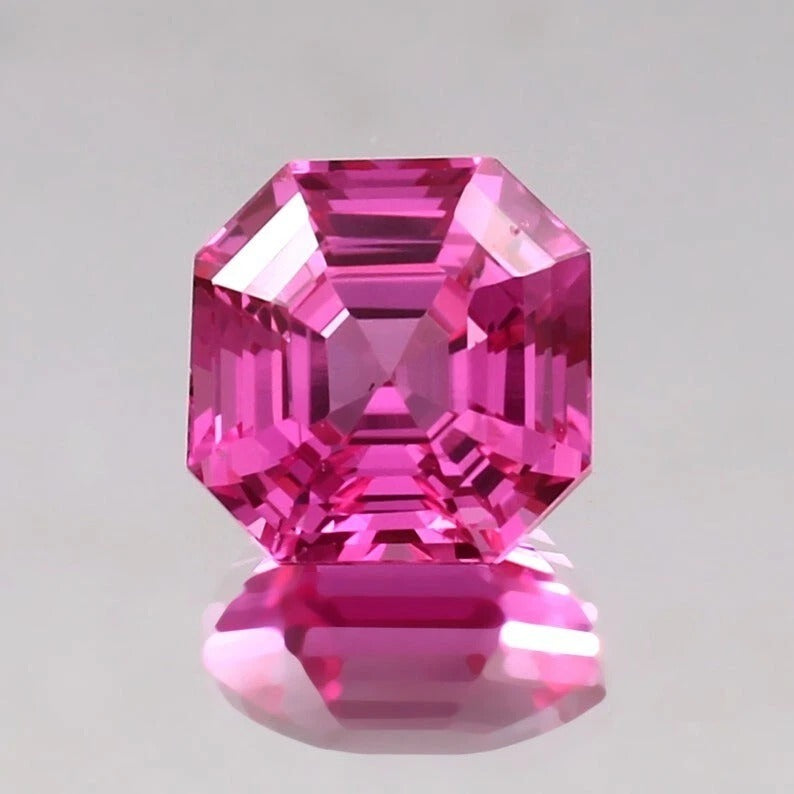 Pink sapphire asscher gemstone with a clear background