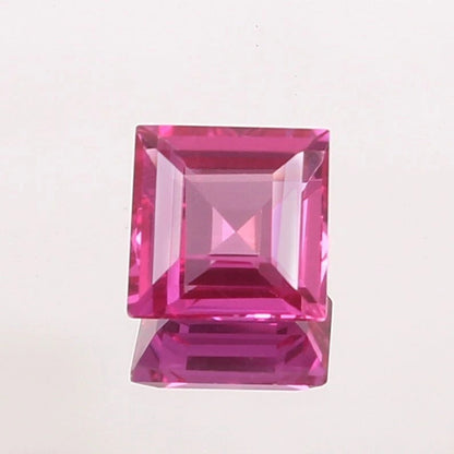 Pink Sapphire gemstone with a clear cut on a light pink background