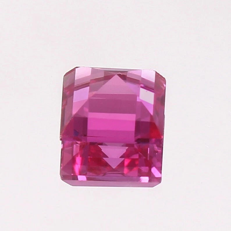 Pink Sapphire gemstone on a light purple background