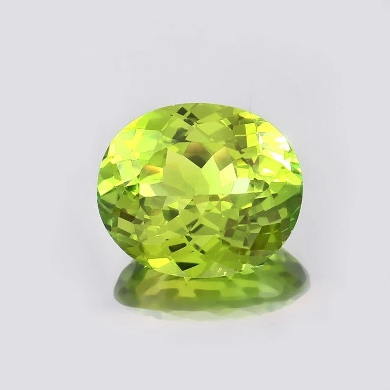 Green Peridot gemstone on a light gray background