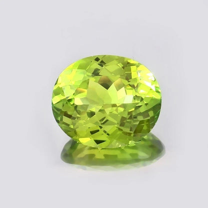 Green Peridot gemstone on a light gray background