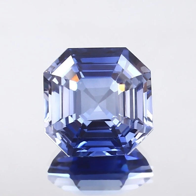 Faceted Ceylon Blue Sapphire gemstone on a light gray background