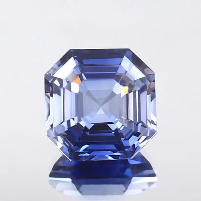 Faceted Ceylon Blue Sapphire gemstone on a light gray background