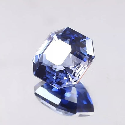 Faceted Ceylon Blue Sapphire gemstone on a light gray background