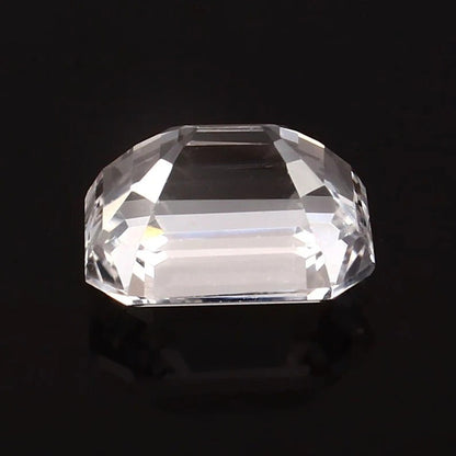 Clear emerald cut white sapphire on a black background