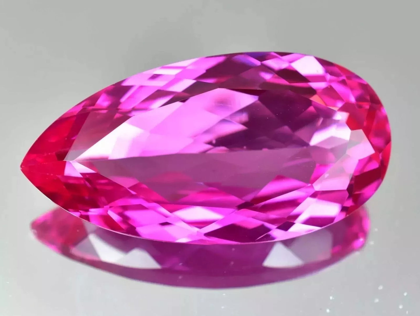 pink ruby on reflective surface