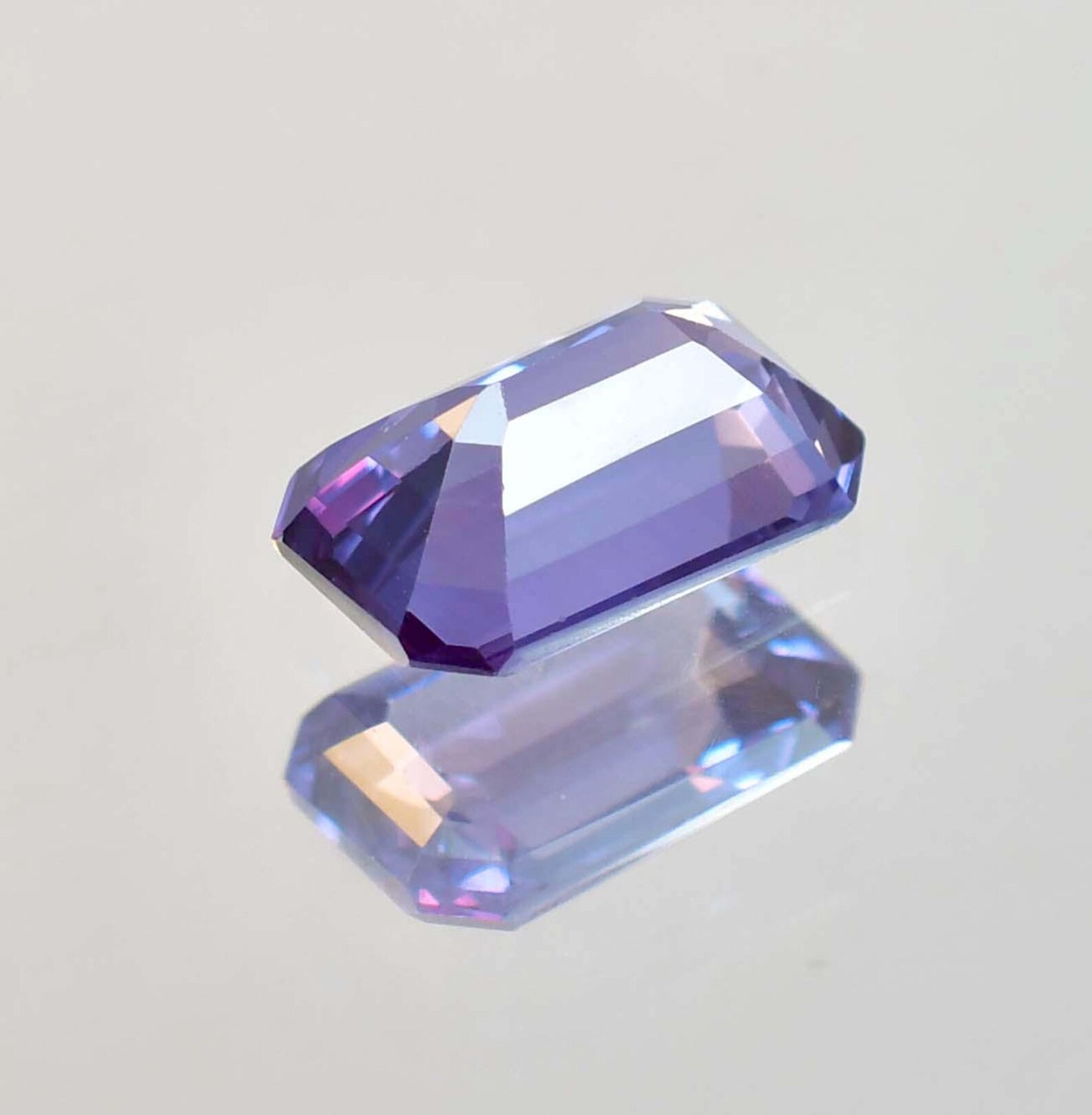 Alexandrite  gemstone on a gray background