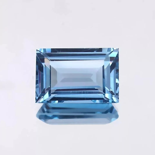 blue Aquamarine gemstone on a light gray background