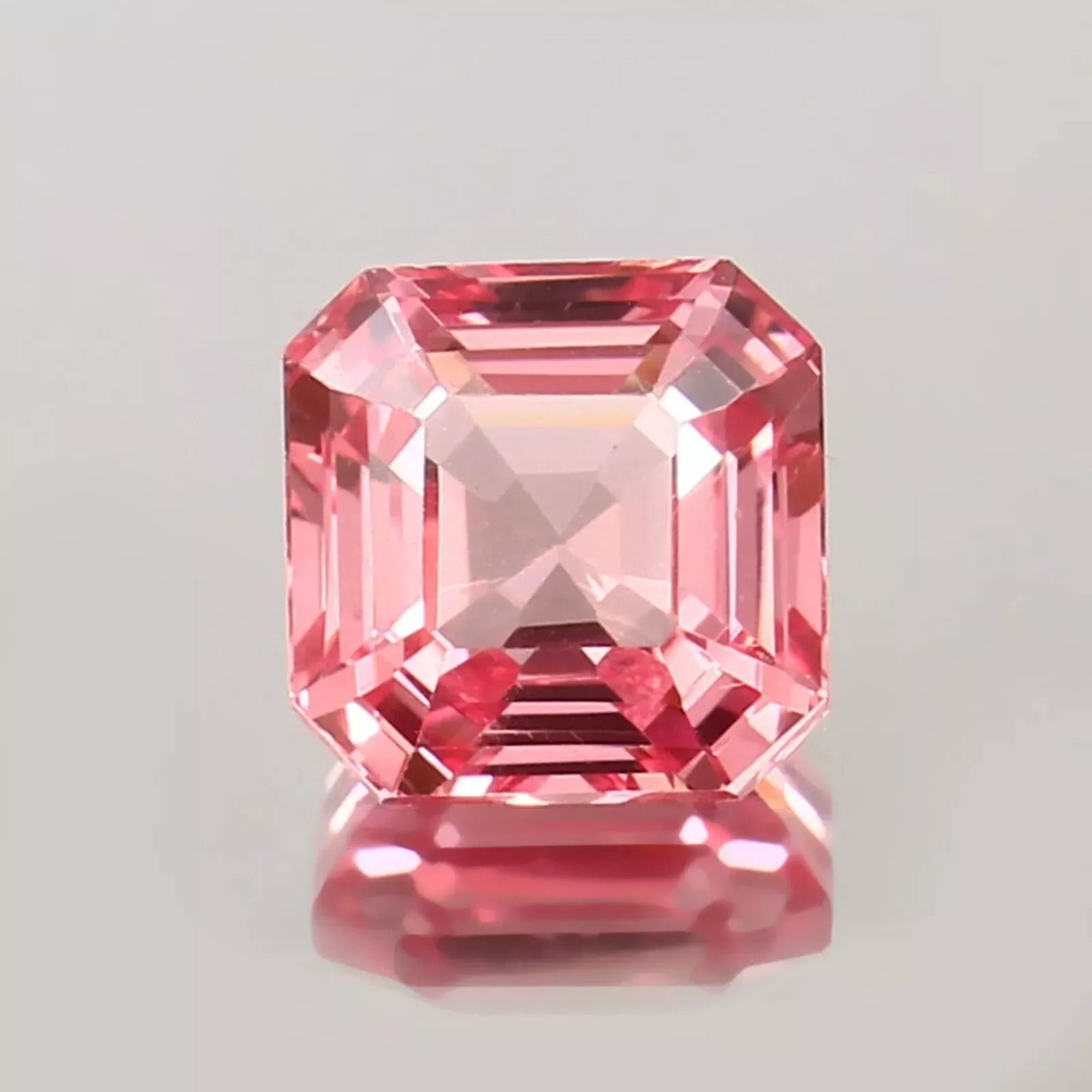 Padparadscha Sapphire gemstone with a clear background