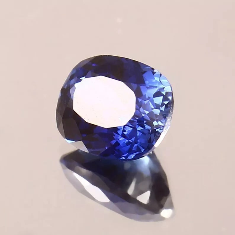 Royal Blue Sapphire gemstone on a beige background