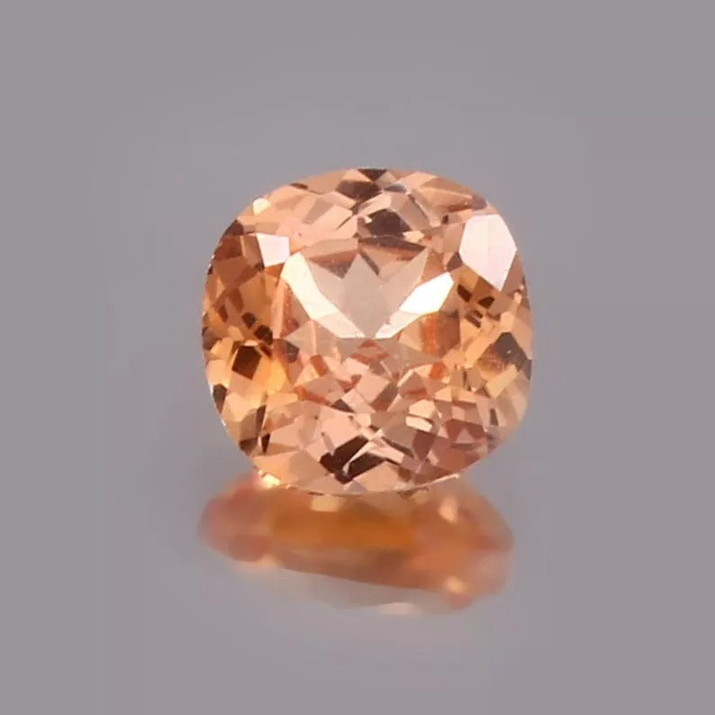 Padparadscha Sapphire – Peach to Orange gemstone on a gray background