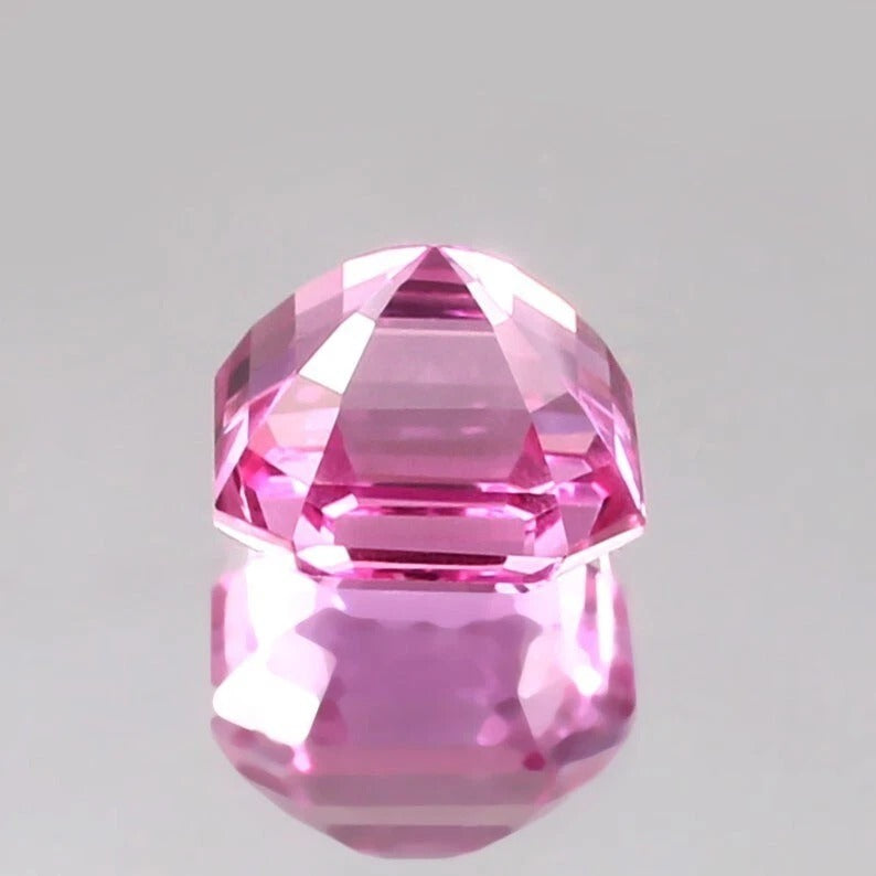 Faceted Pink Sapphire Loose Asscher Unheated gemstone on a gray background