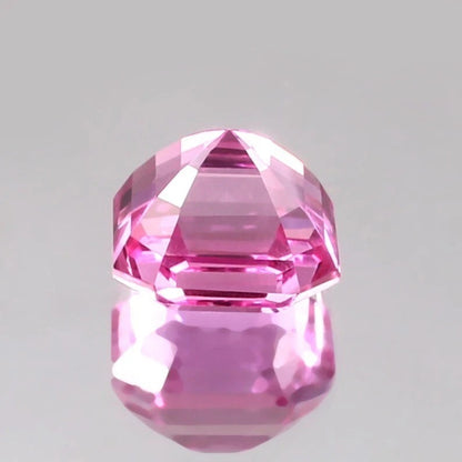 Faceted Pink Sapphire Loose Asscher Unheated gemstone on a gray background