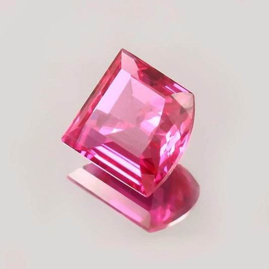 Pink Sapphire Fancy Cut gemstone on a light gray background