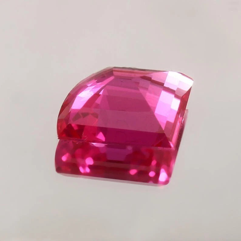 Pink Sapphire Fancy Cut gemstone on a light gray background