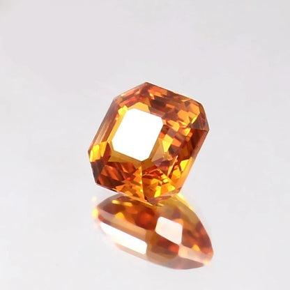 Faceted Ceylon Fanta Orange Sapphire Untreated gemstone on a light gray background