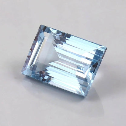 Brazilian Aquamarine Loose Baguette Cut blue gemstone on a light gray background