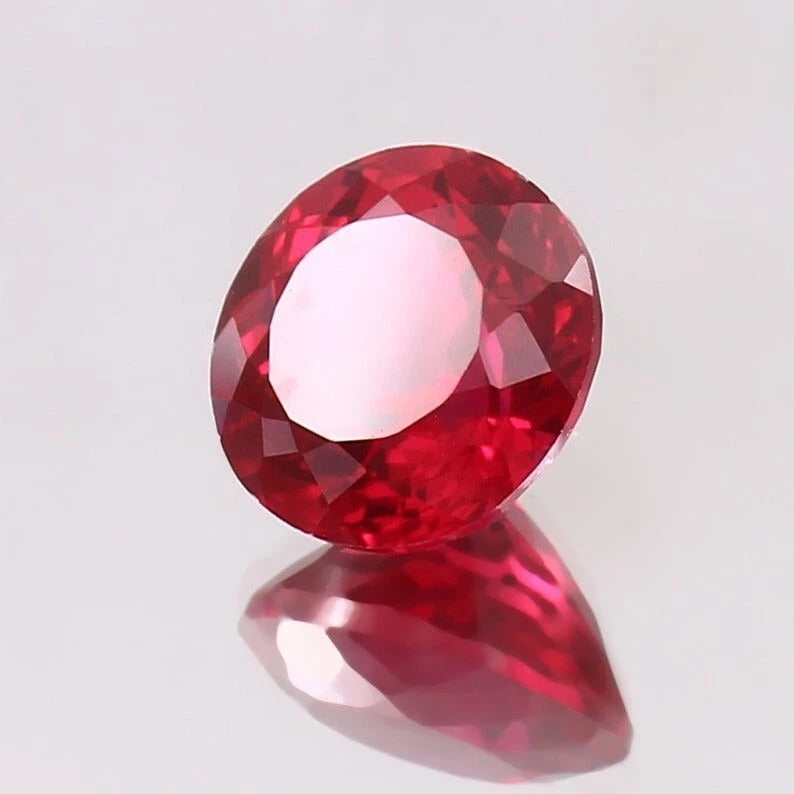 Rare Pigeon Red Ruby gemstone on a light gray background