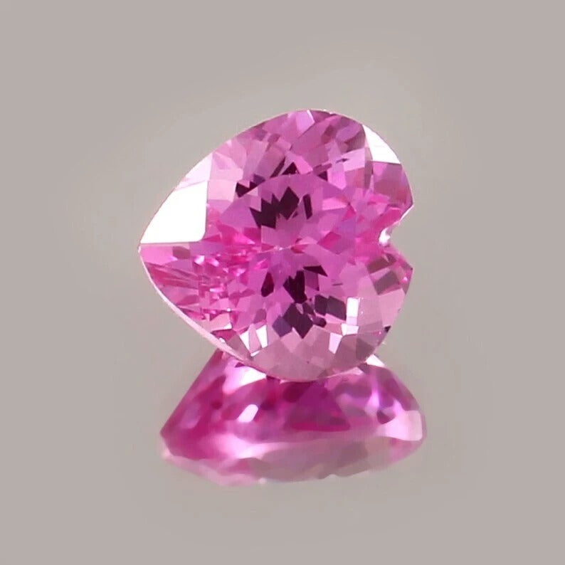 Pink sapphire  gemstone on a gray background