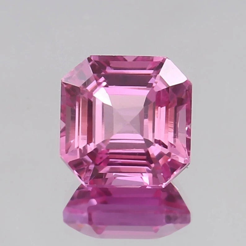 Pink Sapphire Unheated gemstone with a clear gray background