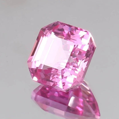 Pink Sapphire Unheated gemstone on a gray background