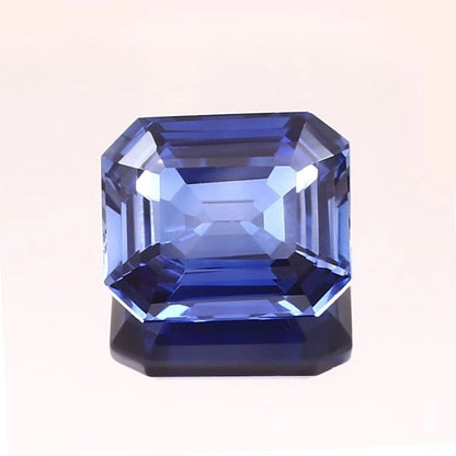Blue Sapphire gemstone with a rectangular cut on a white background