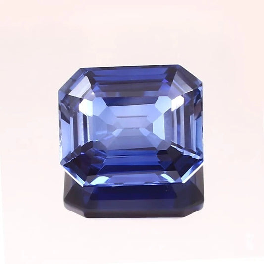 Blue Sapphire gemstone with a rectangular cut on a white background