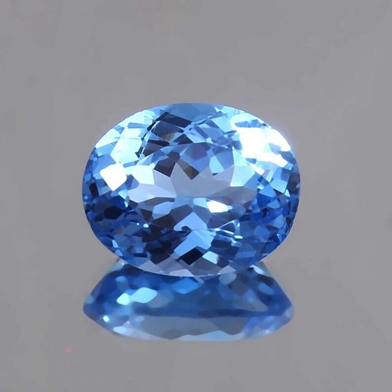 Blue Tourmaline Unheated gemstone on a gray background