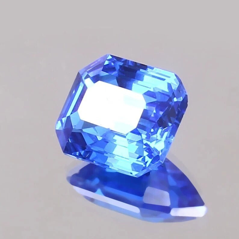 Cornflower Blue Sapphire gemstone on a gray background