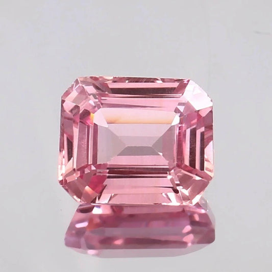 Padparadscha Sapphire gemstone with a clear background