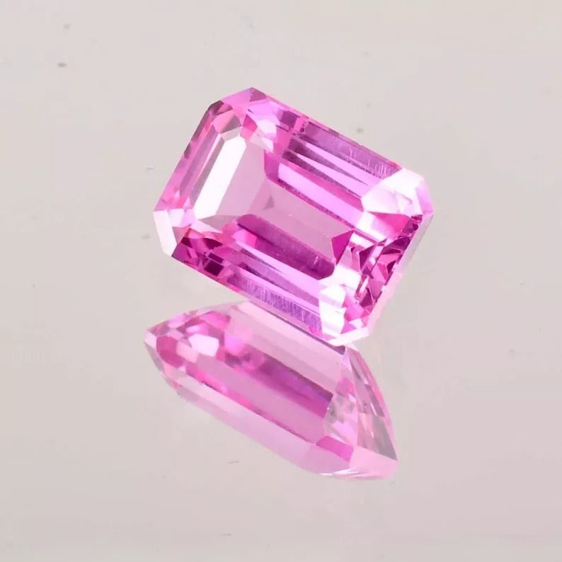Pink Ceylon Sapphire gemstone on a light gray background