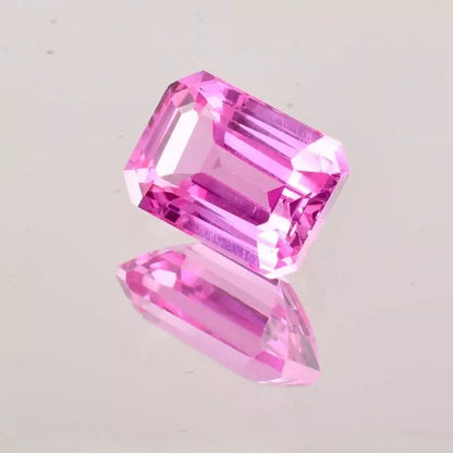 Pink Ceylon Sapphire gemstone on a light gray background