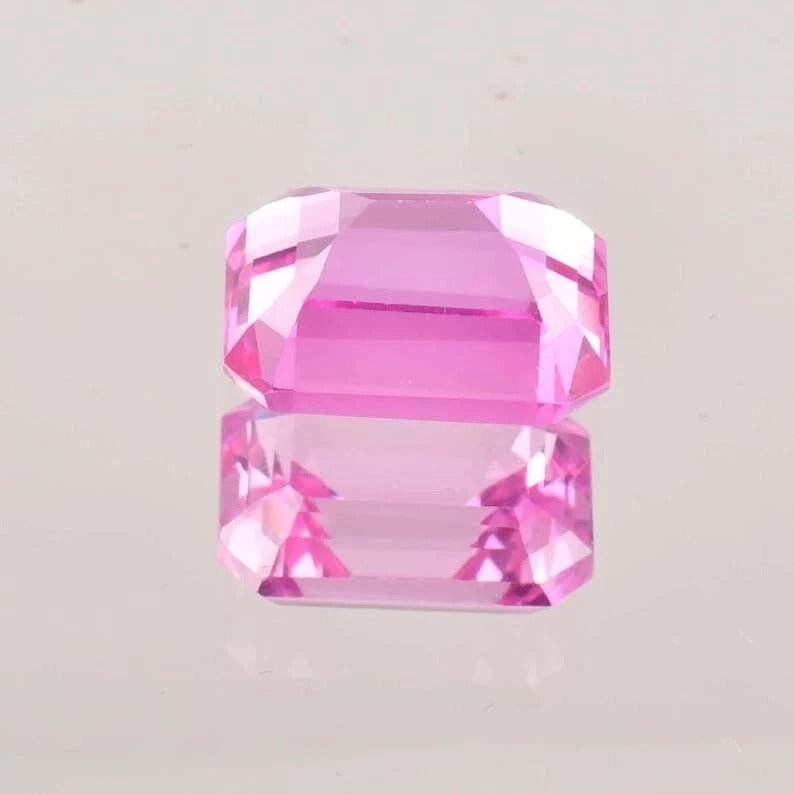 Pink Ceylon Sapphire gemstone on a light gray background