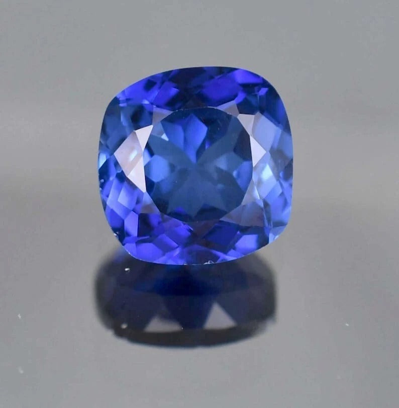 Blue Sapphire cushion-shaped blue gemstone on a gray background