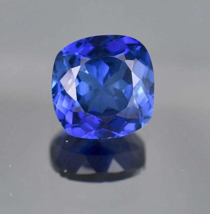 Blue Sapphire cushion-shaped blue gemstone on a gray background