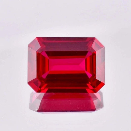 Pigeon Blood Ruby red gemstone on a light gray background