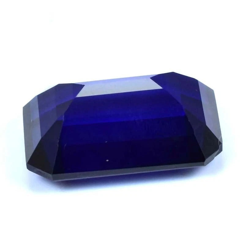 Faceted blue Sapphire gemstone on a white background