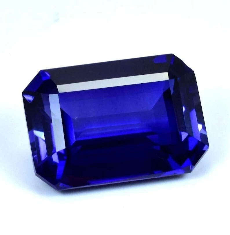 Faceted blue Sapphire gemstone on a white background
