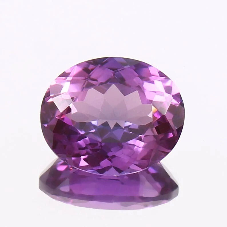 Purple Taaffeite gemstone on a white background