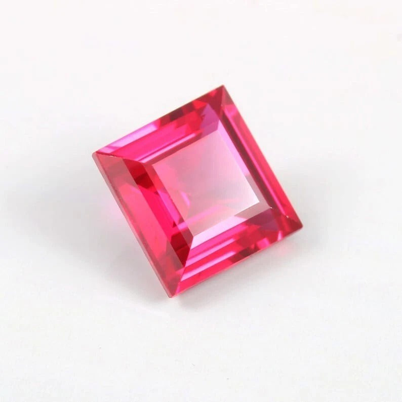 Square-cut red Mozambique Ruby gemstone on a white background